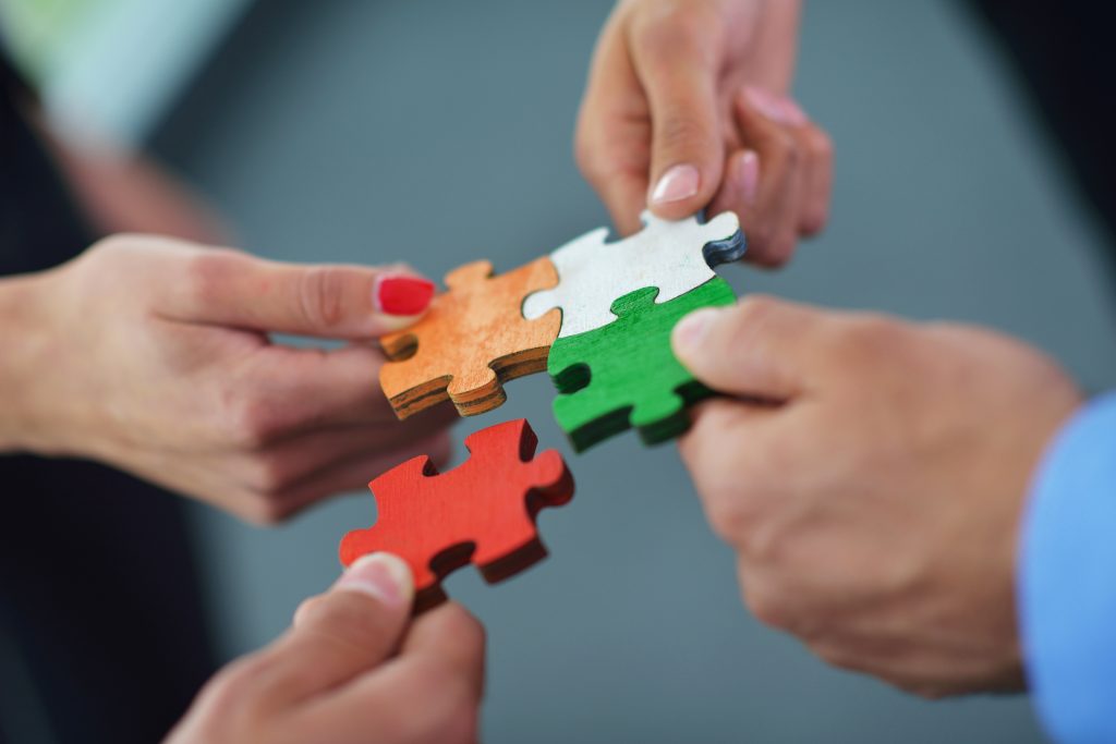 Group of business people assembling jigsaw puzzle Group of business people assembling jigsaw puzzle